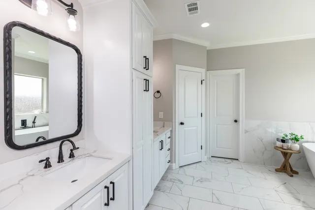 a bathroom with a double vanity sink and a mirror