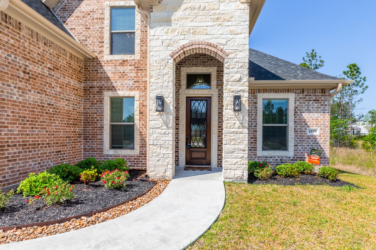 1880 Brenner Boulevard Lumberton, TX 77657 - Photo 2 of 32 a front view of a house with potted plants
