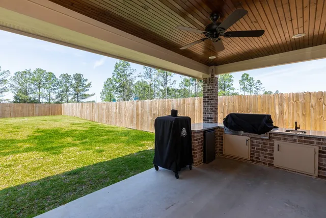 a view of an outdoor kitchen and dining space