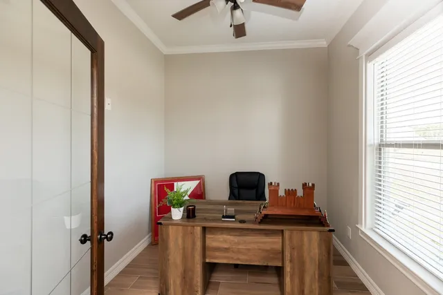 a view of a workspace with furniture and window