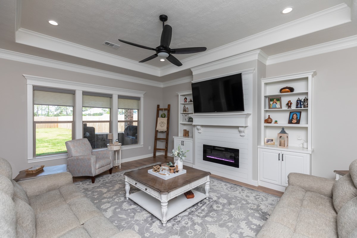 1880 Brenner Boulevard Lumberton, TX 77657 - Photo 5 of 32 a living room with furniture a flat screen tv and a fireplace