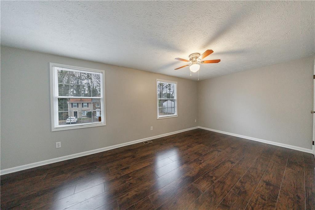 1960 Hamilton Place Southeast Marietta, GA 30067 - Photo 11 of 22 an empty room with wooden floor and window