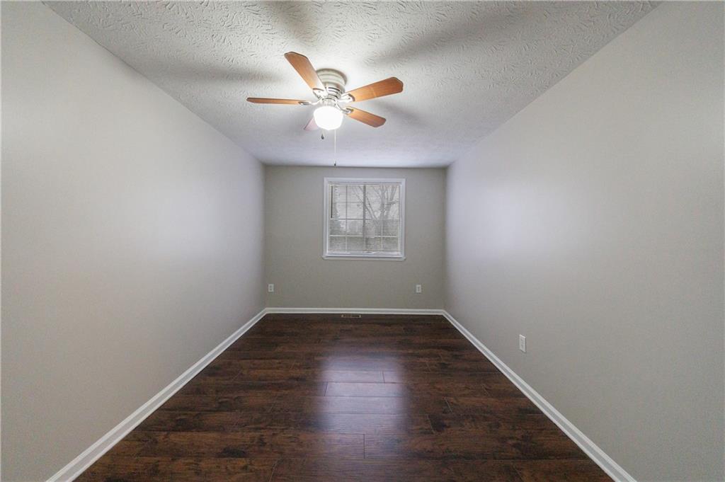 1960 Hamilton Place Southeast Marietta, GA 30067 - Photo 20 of 22 an empty room with windows and fan