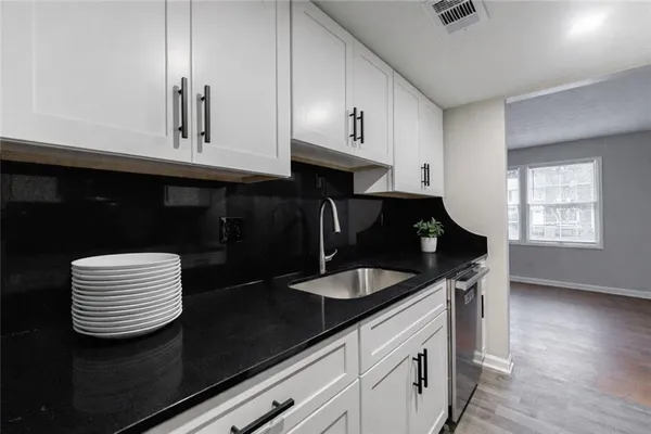 a kitchen with a sink and cabinets