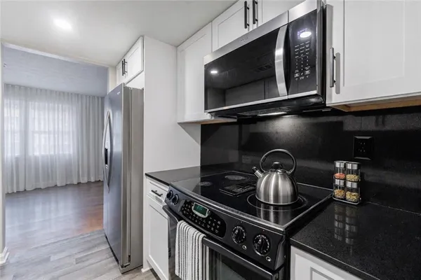 a kitchen with a stove and a microwave