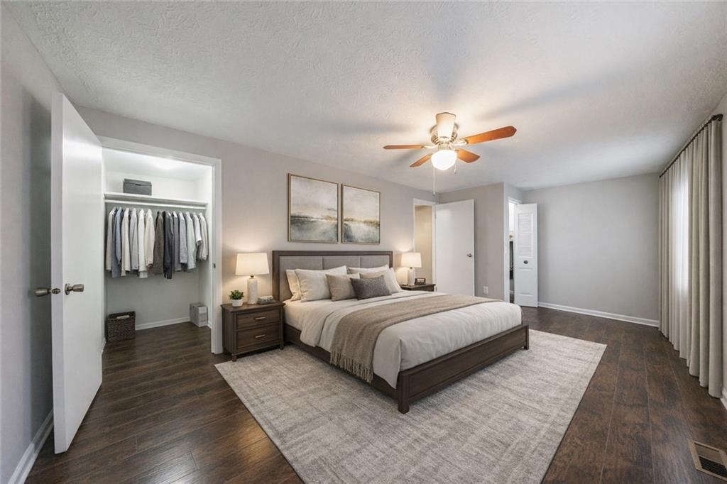 1960 Hamilton Place Southeast Marietta, GA 30067 - Photo 8 of 22 a bedroom with a bed and a ceiling fan