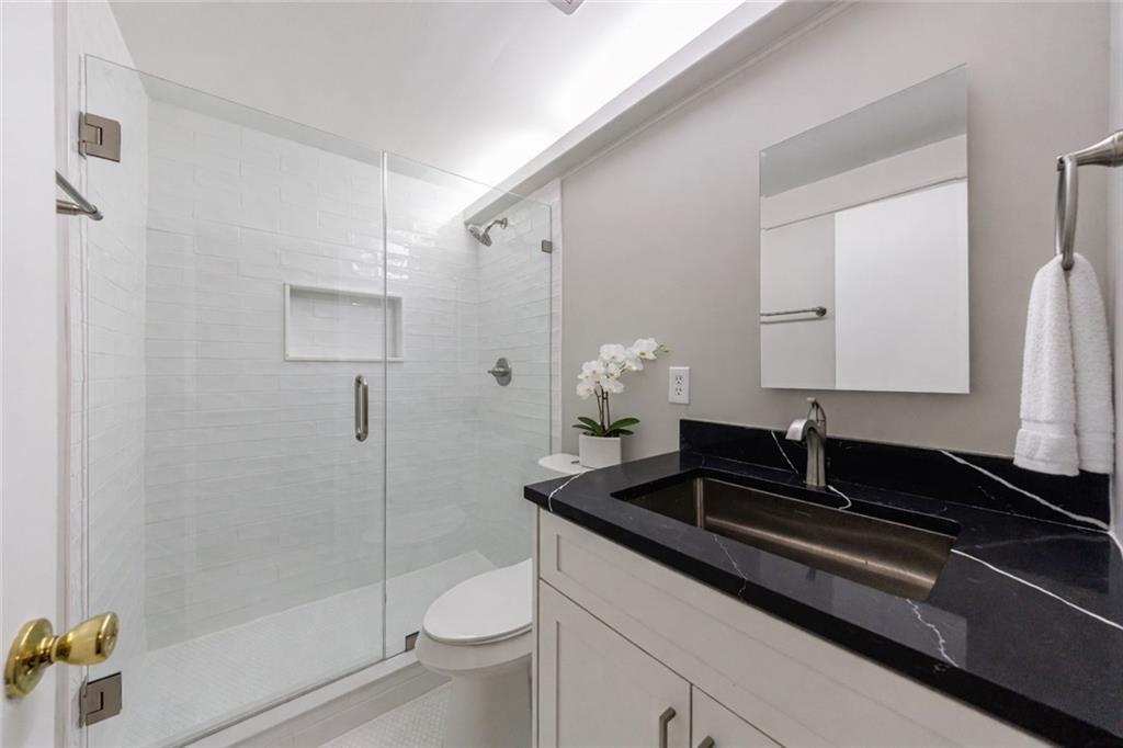 1960 Hamilton Place Southeast Marietta, GA 30067 - Photo 9 of 22 a bathroom with a granite countertop sink a toilet and shower