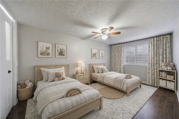 a bedroom with two beds and a chandelier