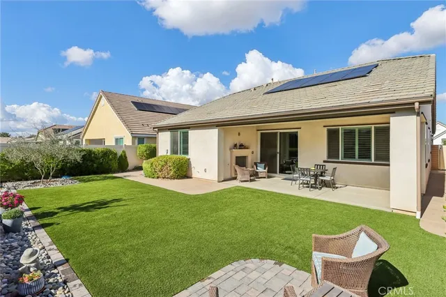 a view of a house with backyard porch and sitting area