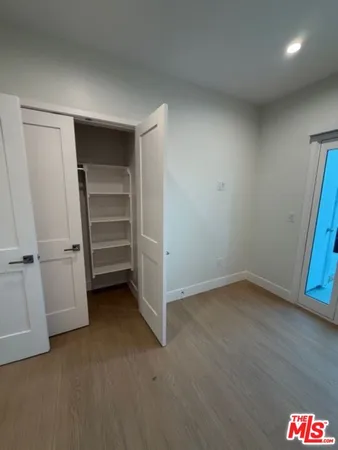 a view of an empty room and wooden floor
