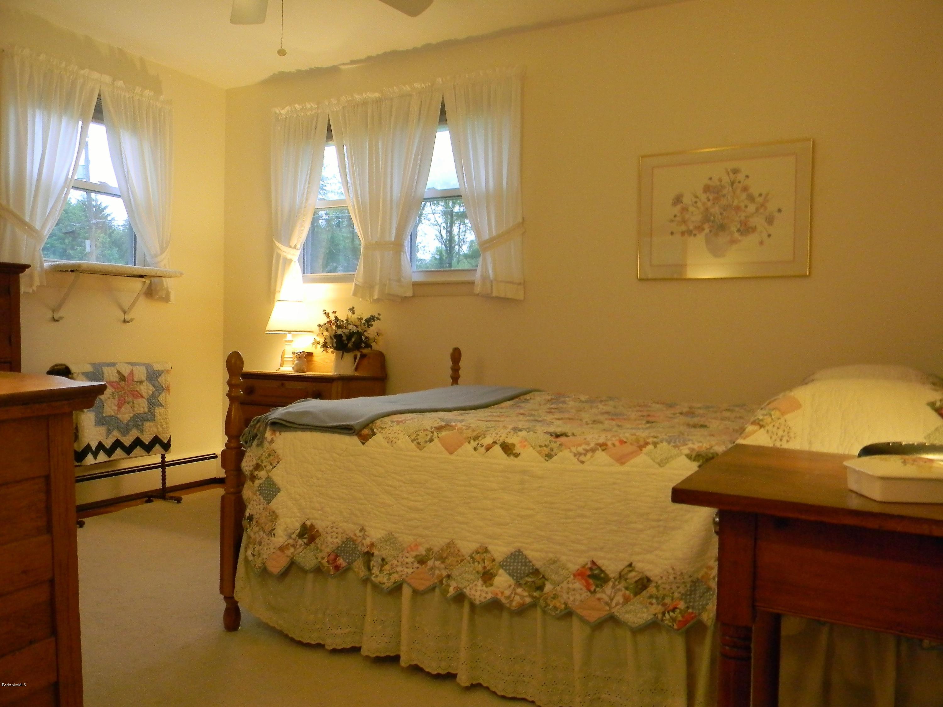 9 Balance Rock Road Lanesborough, MA 01237 - Photo 11 of 20 a bed sitting in a bedroom next to a window