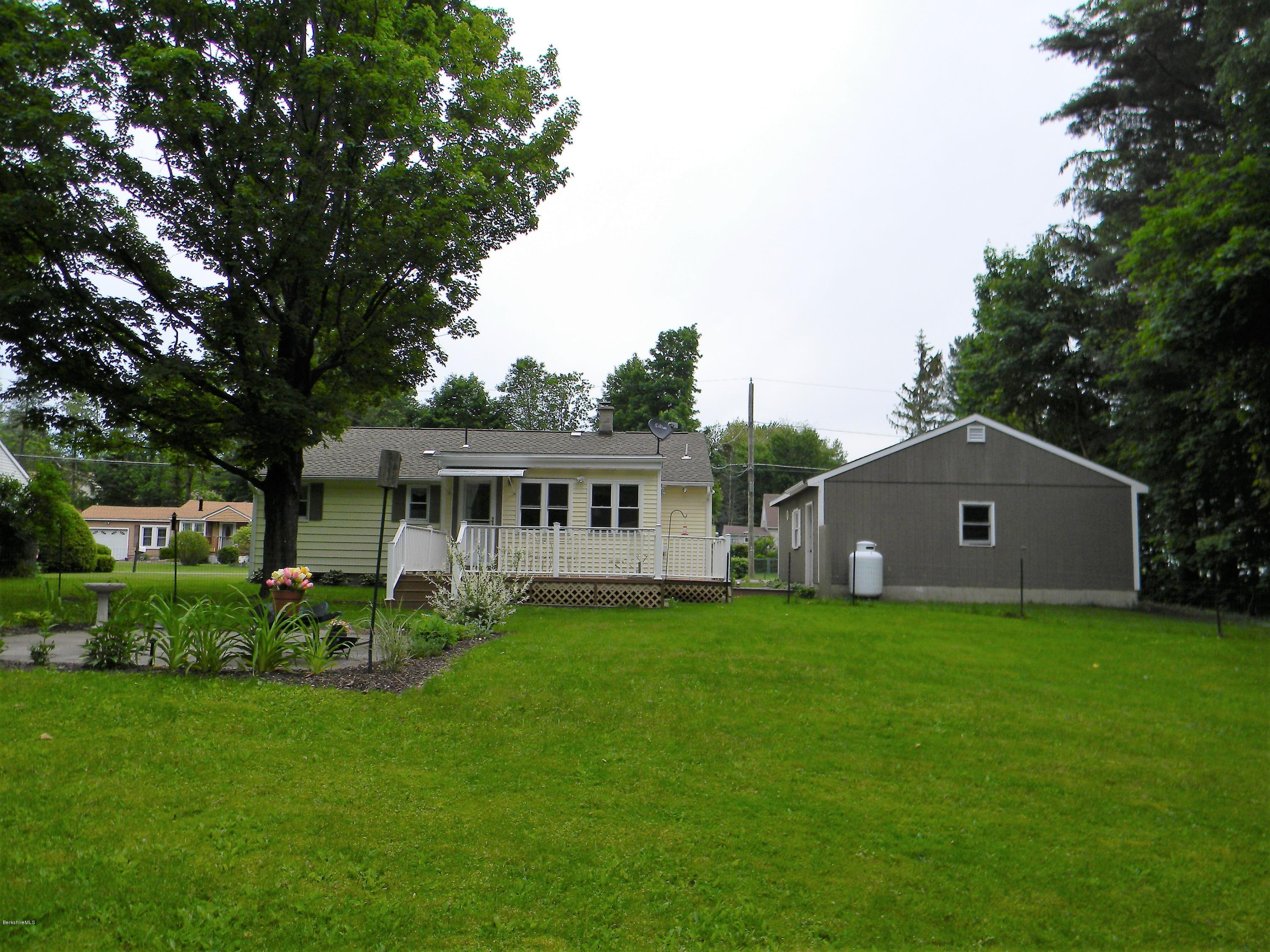 9 Balance Rock Road Lanesborough, MA 01237 - Photo 19 of 20 a house that is sitting in the grass with large trees and plants