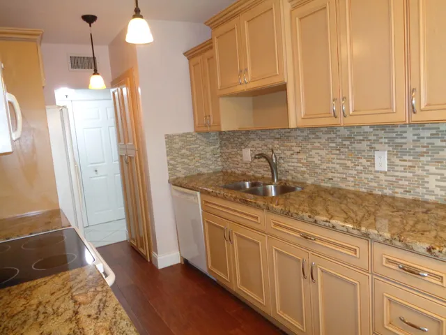 a kitchen with cabinets and a wooden floor