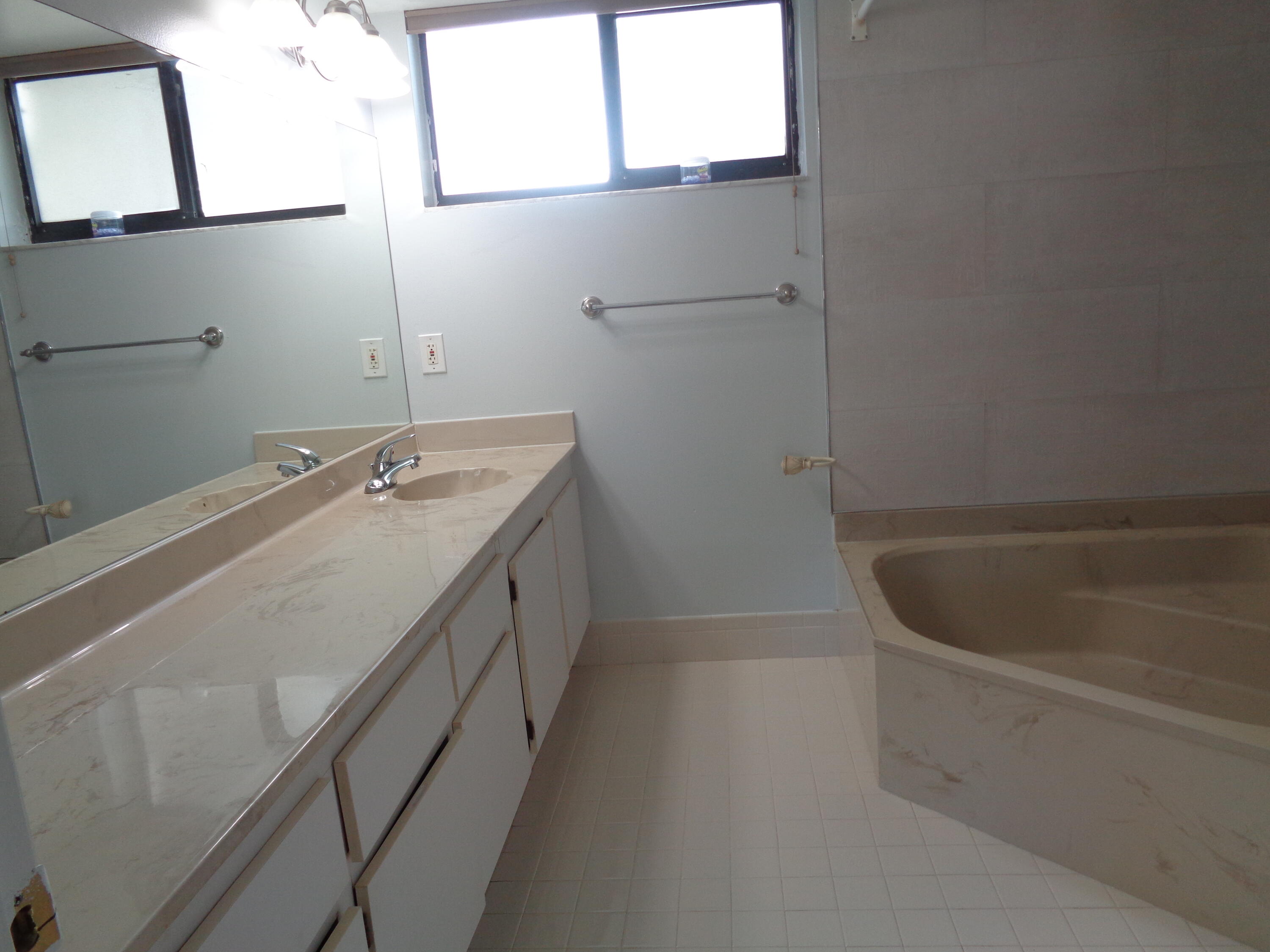 6328 Longboat Lane West, Unit 201 Boca Raton, FL 33433 - Photo 9 of 16 a bathroom with a tub sink and vanity