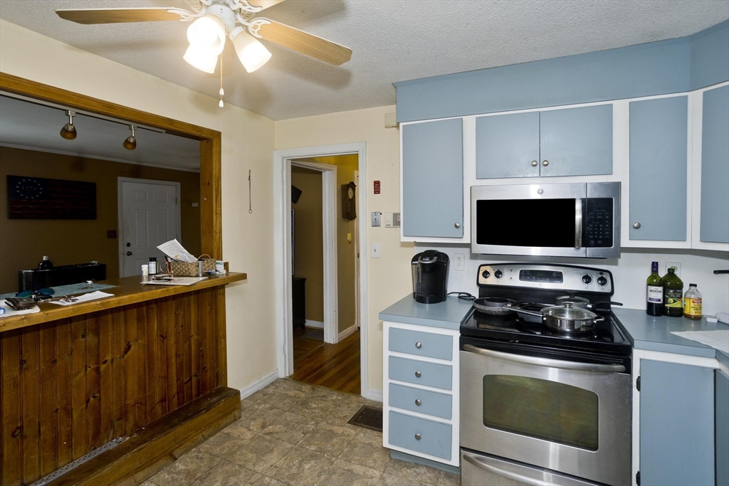 88 Surrey Road Springfield, MA 01118 - Photo 8 of 34 a kitchen with stainless steel appliances a stove and a microwave