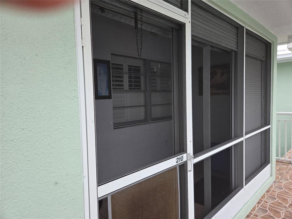 2100 Northeast 38th Street, Unit 210 Lighthouse Point, FL 33064 - Photo 12 of 12 Lanai overlooks the pool and gardens