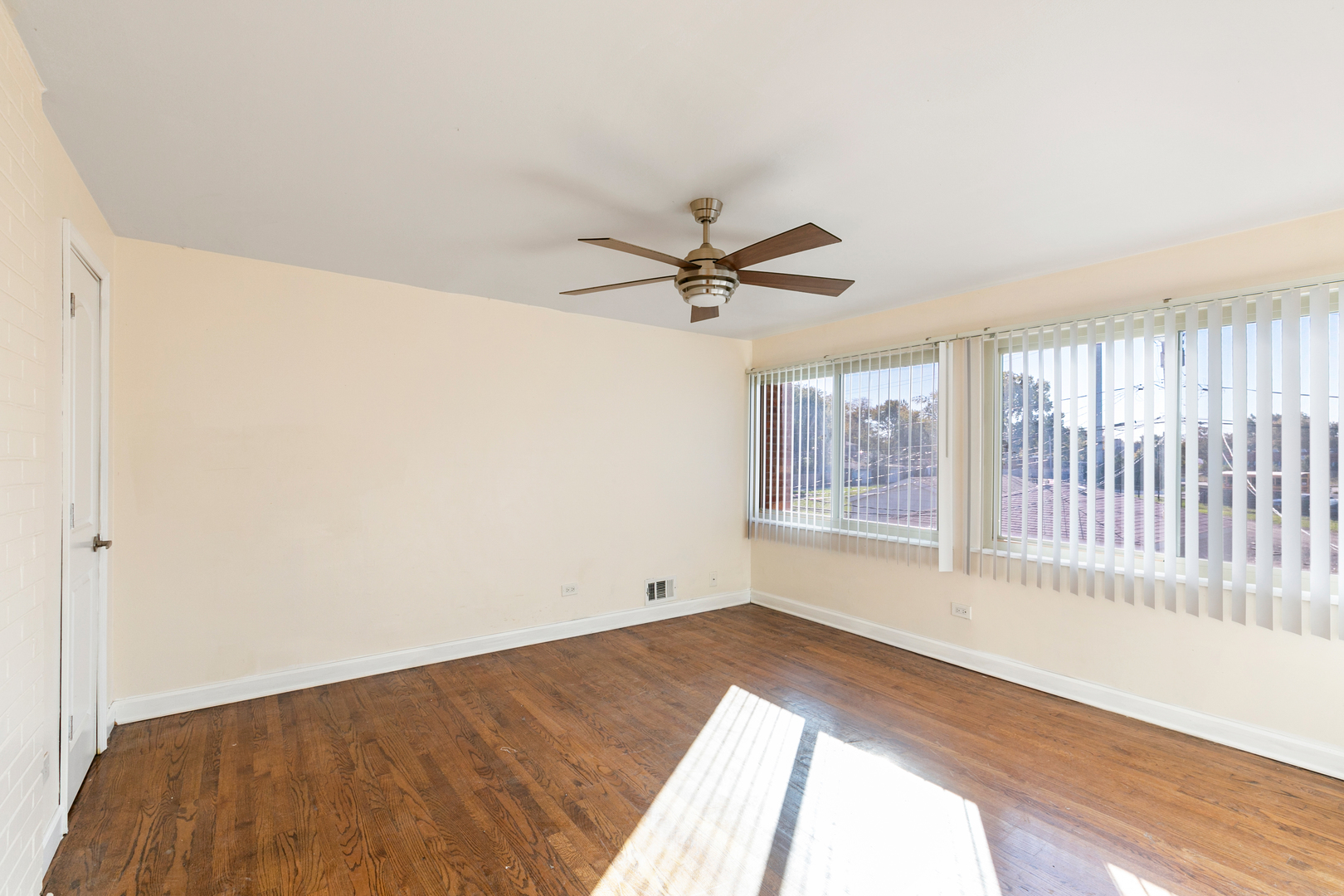 1731 East 74th Street Chicago, IL 60649 - Photo 11 of 19 a view of a livingroom with wooden floor and a ceiling fan