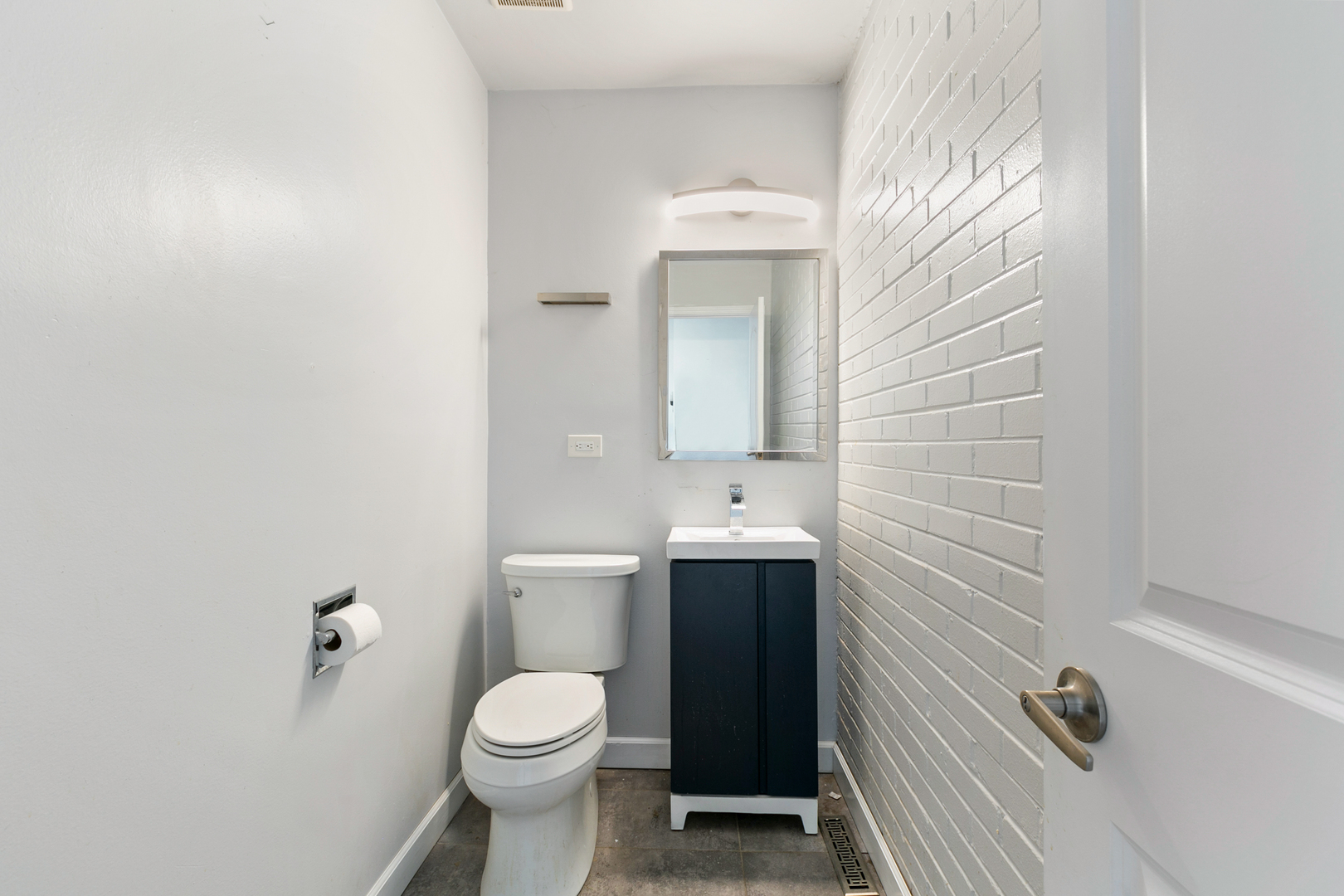 1731 East 74th Street Chicago, IL 60649 - Photo 9 of 19 a bathroom with a toilet sink and mirror