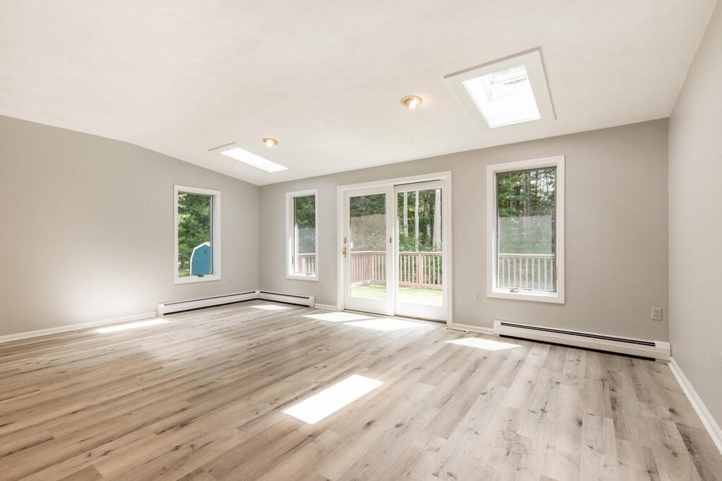 108 Blanchard Road Boxborough, MA 01719 - Photo 8 of 27 a view of an empty room with wooden floor and a window