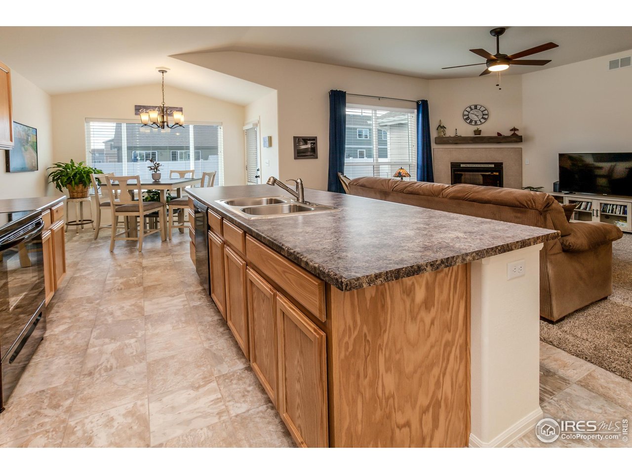 944 Maplebrook Drive Windsor, CO 80550 - Photo 14 of 32 a dining hall with stainless steel appliances granite countertop a sink a stove and a refrigerator