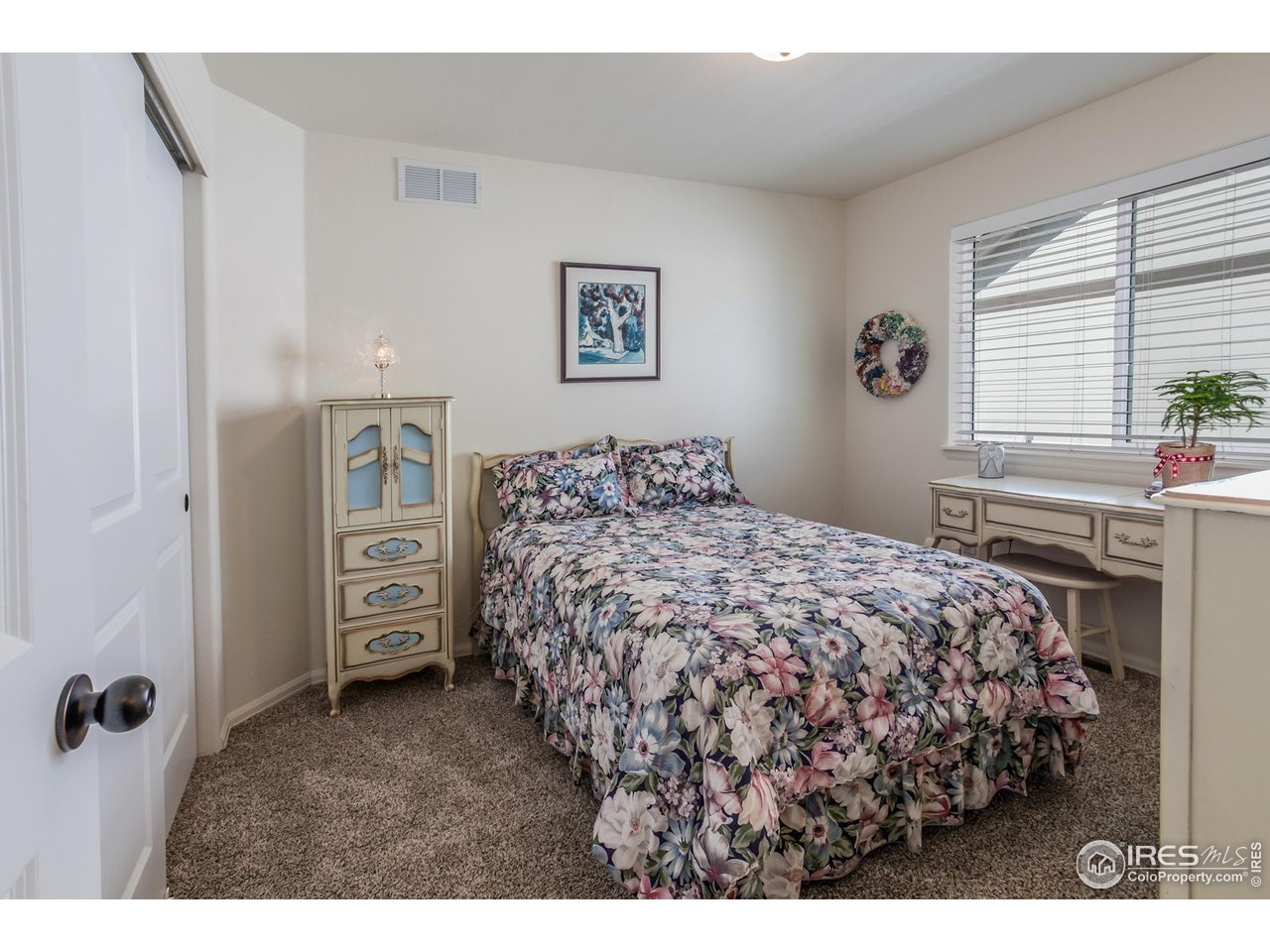 944 Maplebrook Drive Windsor, CO 80550 - Photo 21 of 32 a bedroom with a bed and a window