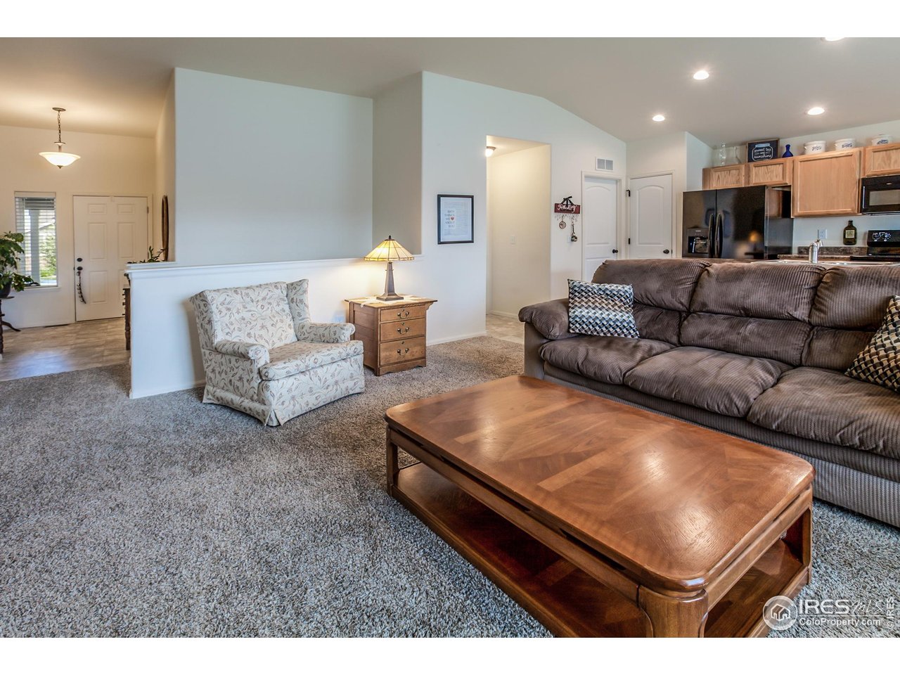 944 Maplebrook Drive Windsor, CO 80550 - Photo 5 of 32 a living room with furniture and kitchen view