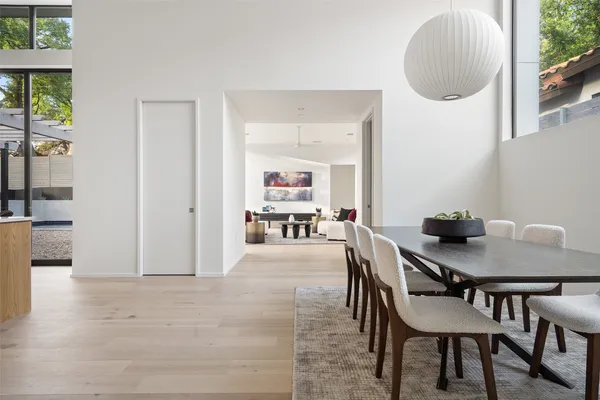 a dining room with furniture and a painting