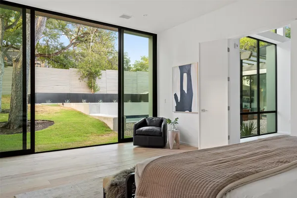 a bedroom with a bed and glass door