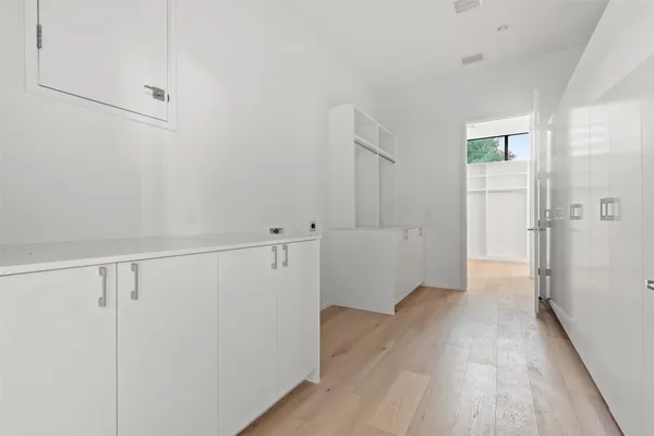 a view of a hallway with wooden floor