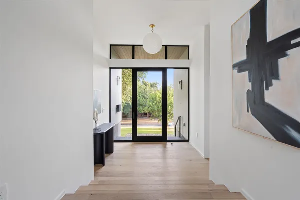 a view of an entryway with wooden floor