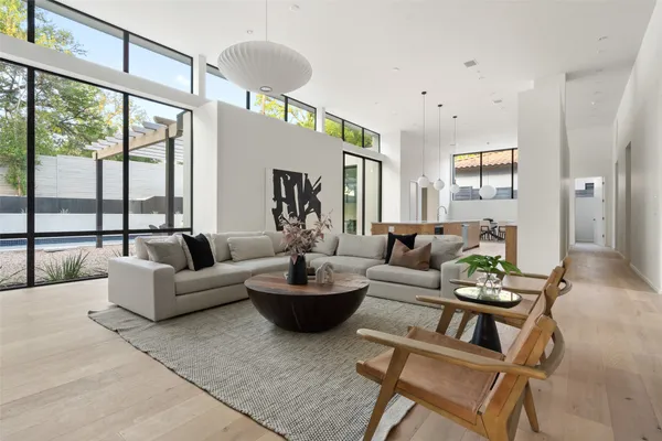 a living room with fireplace furniture and a large window