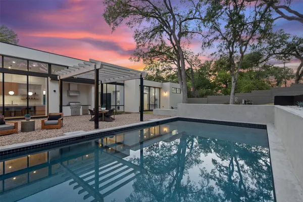 a view of a swimming pool with outdoor seating