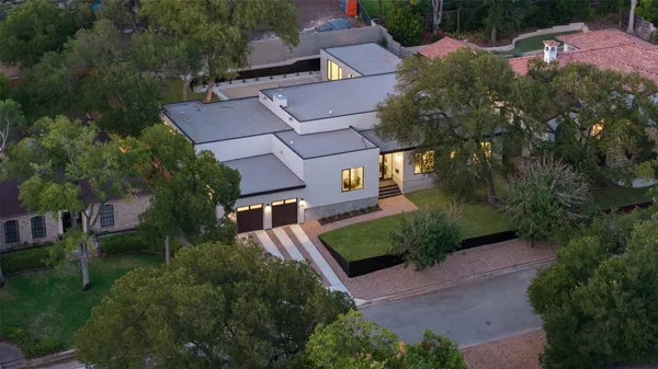 an aerial view of a house with a yard