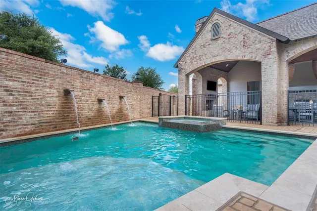 a view of a house with backyard and porch