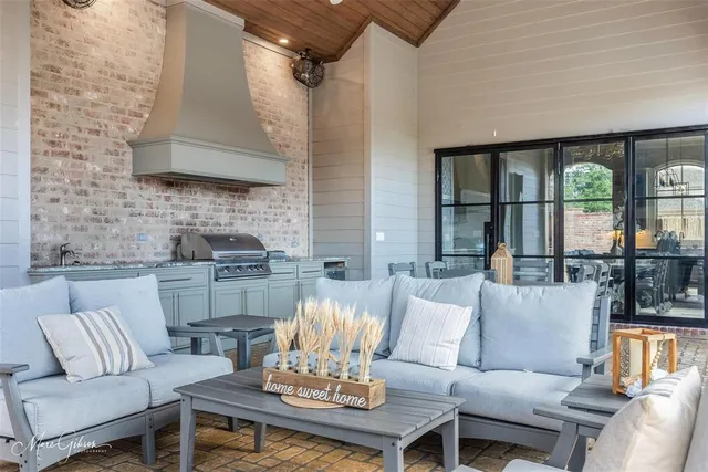 a living room with furniture and floor to ceiling windows