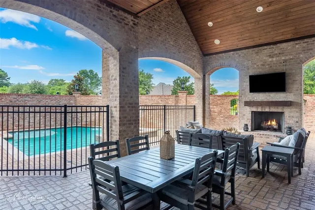 a view of a patio with a table chairs and a fire pit