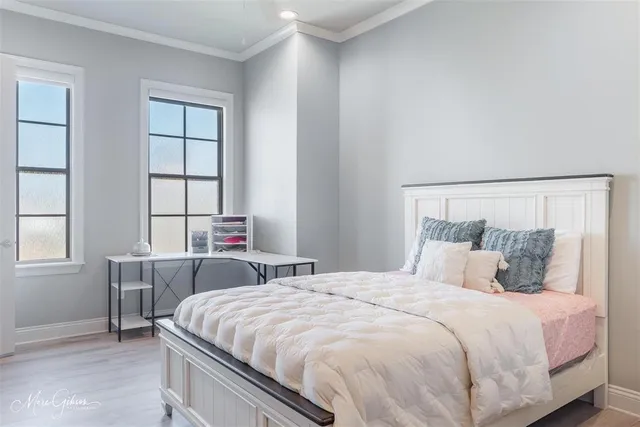 a bedroom with a large bed and a window