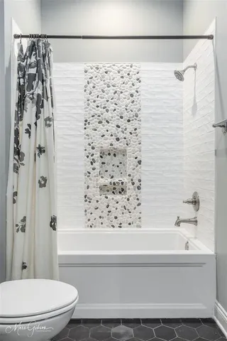 a bathroom with a bathtub and shower