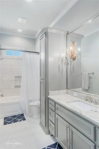 a bathroom with a granite countertop sink a toilet and shower