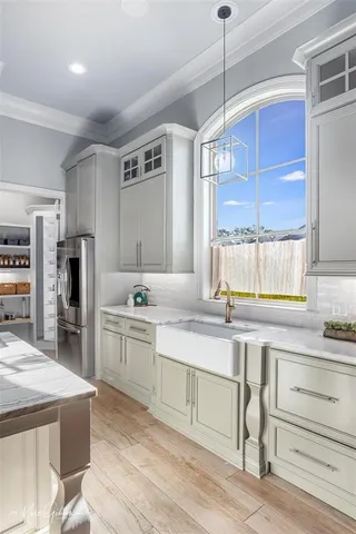 a kitchen with a sink cabinets and window