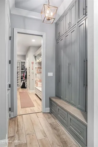 a kitchen with stainless steel appliances granite countertop a sink and cabinets with wooden floor