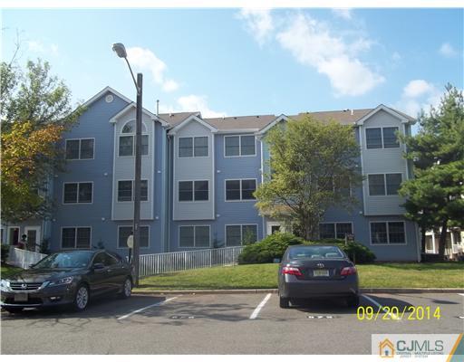 821 Edpas Road New Brunswick, NJ 08901 - Photo 2 of 12 a front view of a residential apartment building with a yard