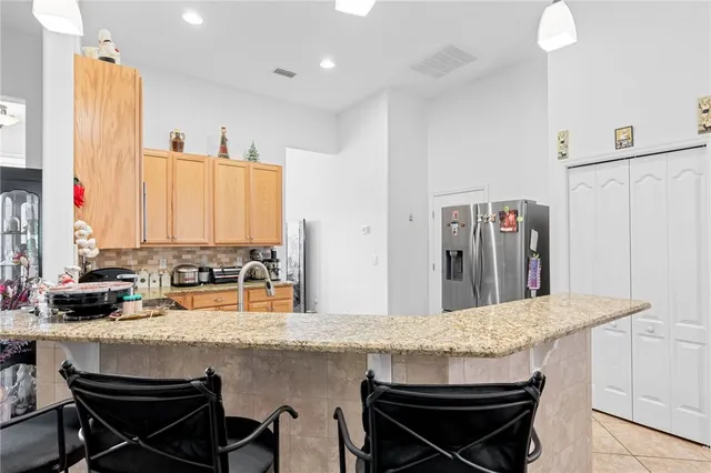 a kitchen with a table chairs sink and cabinets