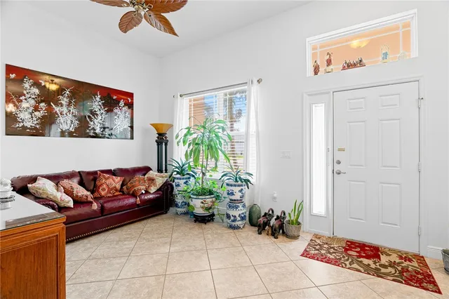 a living room with furniture and a potted plant