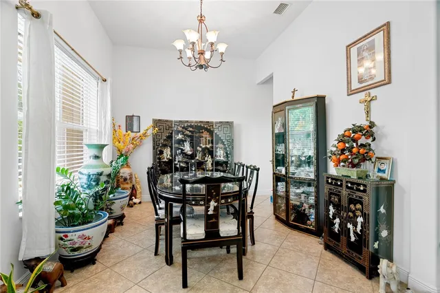 a view of a dining room with furniture and chandelier