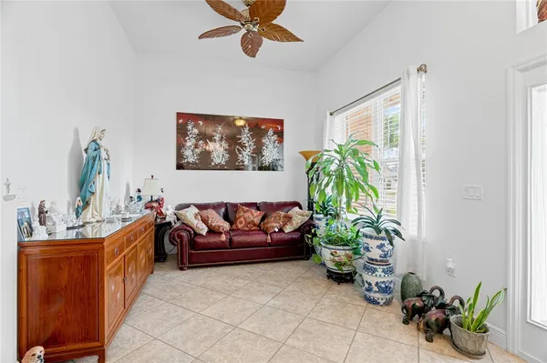 a living room with furniture flowerpot and a chandelier