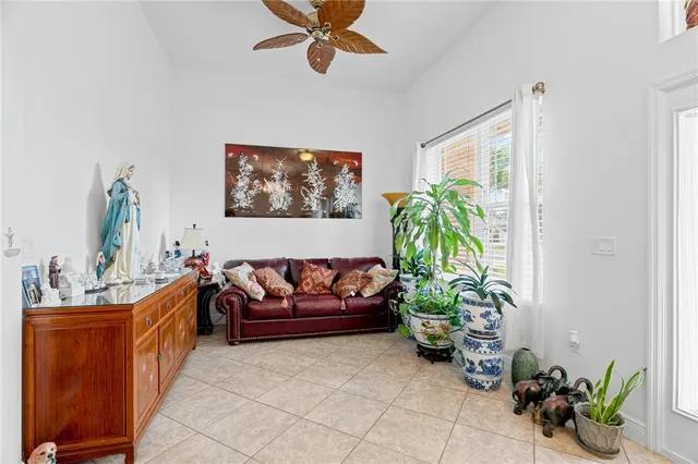 a living room with furniture flowerpot and a chandelier