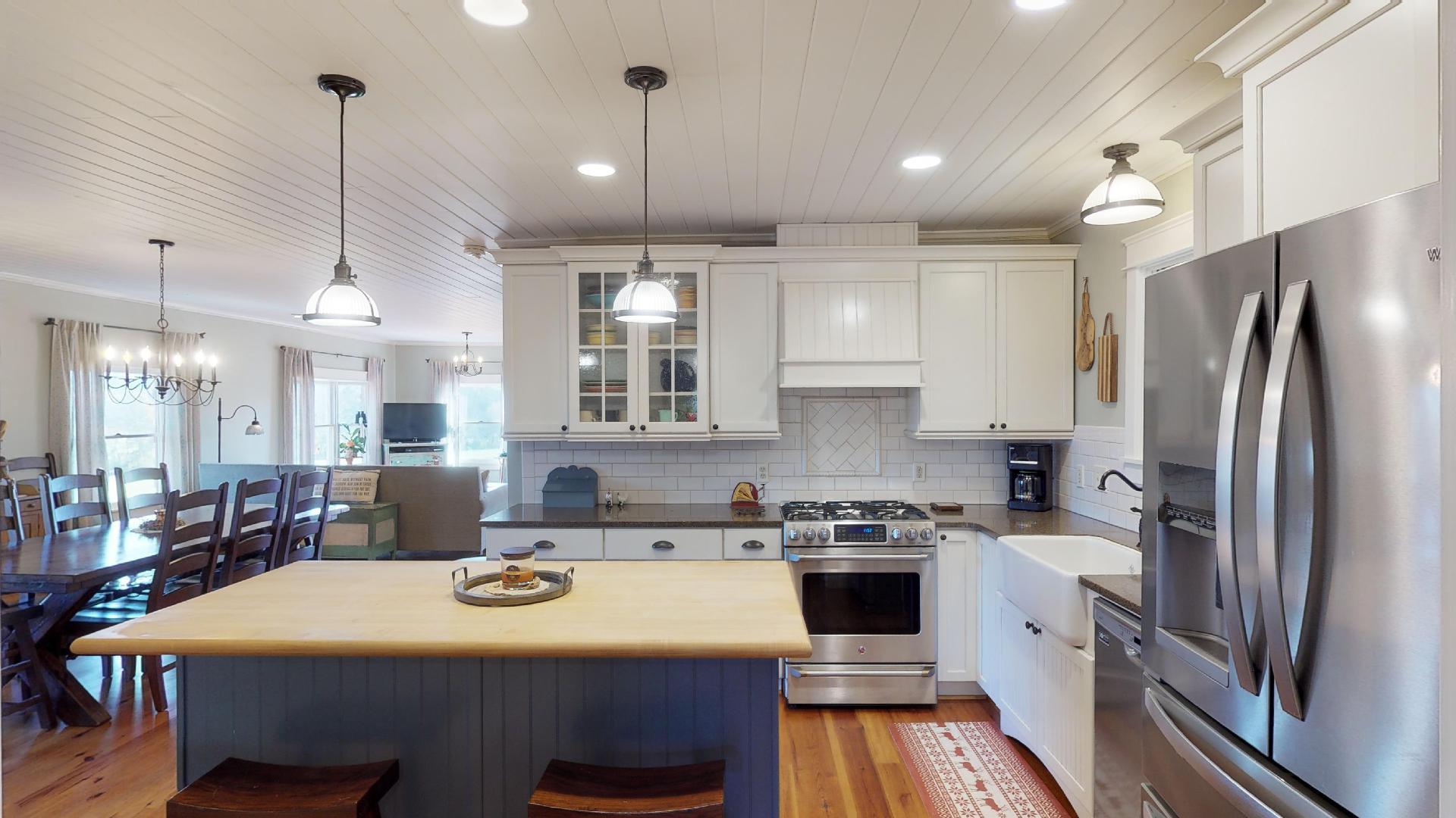 2281 Osburn Road Arrington, TN 37014 - Photo 19 of 29 a kitchen with kitchen island a stove a sink and a refrigerator