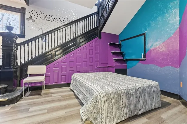 a bedroom with a bed and a chair