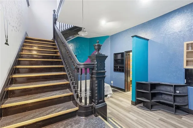 a view of entryway and hall with wooden floor